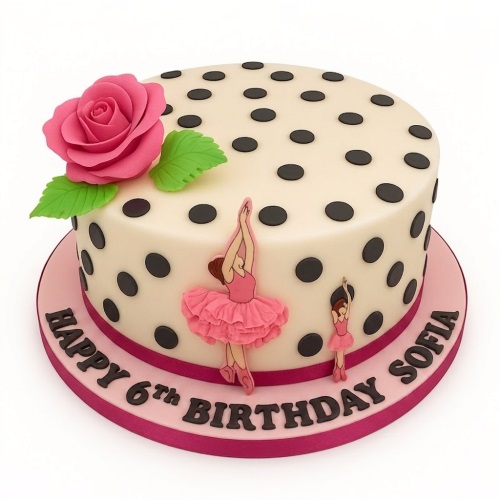 Round cream cake with black polka dots, pink sugar rose, and two pink ballerina figures on a pink board.