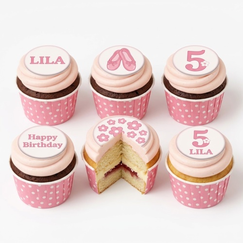 Pink cupcakes with ballet shoes, flowers, custom age, and name toppers in polka dot wrappers.