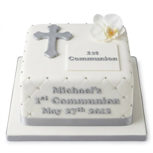 White square First Holy Communion cake with silver cross, white orchid, and silver ribbon.