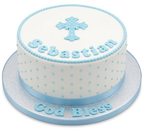 White round christening cake with blue cross, polka dots, and ribbon.