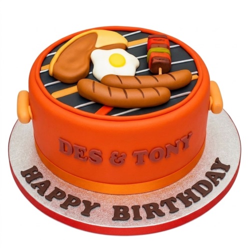 Round orange BBQ grill themed birthday cake with edible sausages, egg, burger, and skewer decorations.