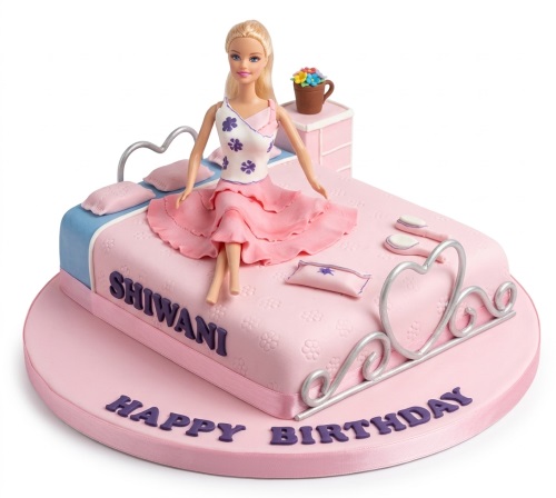 Pink Barbie doll on a bed birthday cake with silver headboard and flowers.
