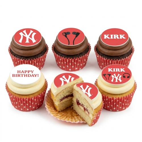 Cupcakes with New York Yankees logo, headphones, and 'Happy Birthday' toppers on red polka dot wrappers.
