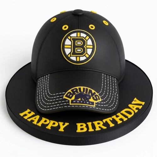 3D Boston Bruins hockey cap birthday cake in black and yellow with "Happy Birthday" text.