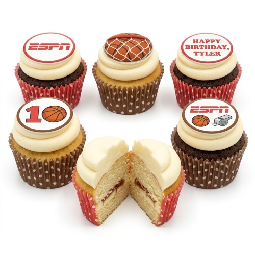 Six cupcakes with white frosting, basketball and ESPN logo toppers, and polka dot wrappers.