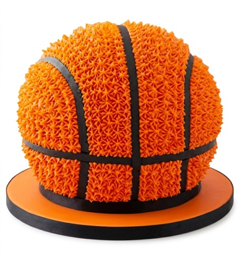 Round orange cake with black lines, resembling a basketball, on an orange and black cake board.