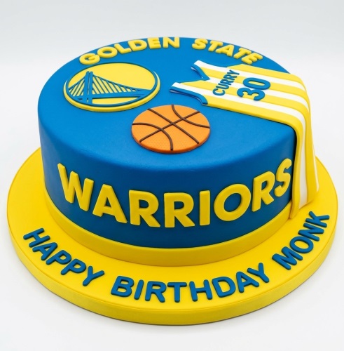 Round blue and yellow Golden State Warriors themed birthday cake with basketball and jersey.