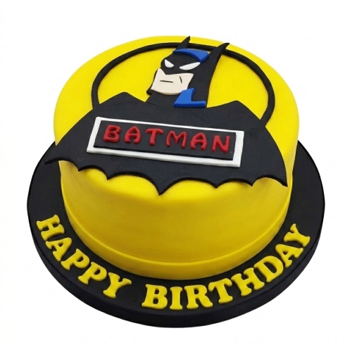 Round yellow and black Batman birthday cake with Batman character bust and 'BATMAN' text, 'HAPPY BIRTHDAY' message on the base.