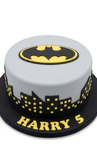Round grey Batman birthday cake with black bat symbol and cityscape, featuring a custom name and age.