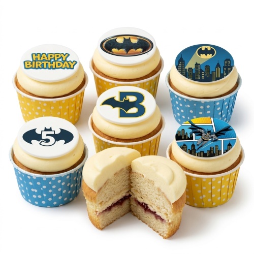Batman themed cupcakes with various Bat-Signal and character toppers, some with custom age numbers, in yellow and blue polka dot cases.