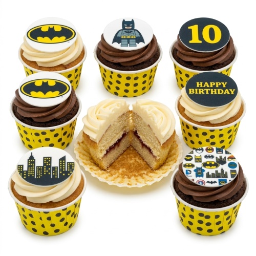 Batman themed cupcakes with various superhero logos, a Lego Batman, city skyline, and custom age and message toppers in yellow and black.