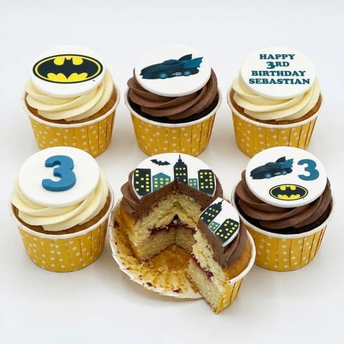 Batman themed birthday cupcakes with Batmobile, cityscape, and custom age topper.