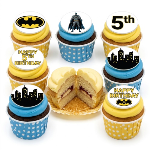 Batman themed cupcakes with yellow and blue frosting, featuring Batman logo, character, and city skyline toppers.