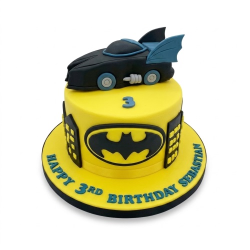 Yellow Batman birthday cake with Batmobile topper, Batman logo, and custom age topper.