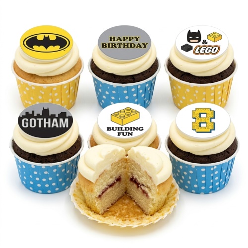 Batman and Lego themed birthday cupcakes with white frosting and various edible toppers.