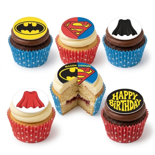 Superhero cupcakes with Batman and Superman logos, capes, and a 'Happy Birthday' topper.