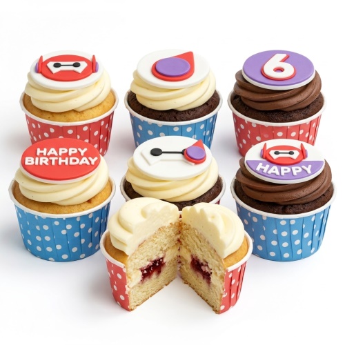 A selection of Big Hero 6 Baymax themed birthday cupcakes with red and blue polka dot cases, featuring Baymax toppers, 'Happy Birthday' message, and a number 6 topper.