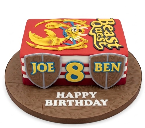 Red book-shaped Beast Quest birthday cake with yellow monster, shields, and custom age.