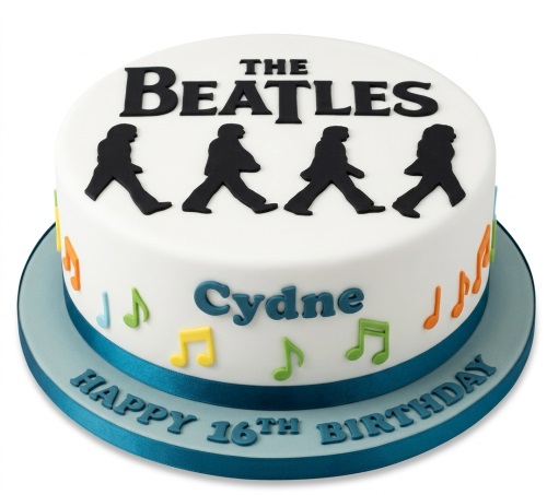 Round white birthday cake with black Beatles Abbey Road silhouettes, colourful musical notes, and a blue base with a personalised message.