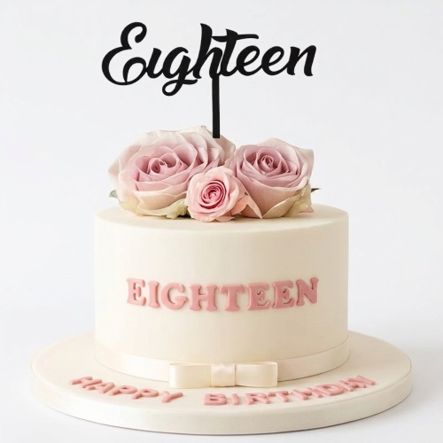 Single-tier cream birthday cake with pink roses and black 'Eighteen' topper, pink 'Happy Birthday' on board.