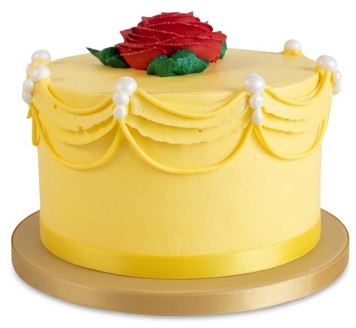 Yellow single-tier cake with red rose, green leaves, draped yellow icing, and white pearl-like decorations on a gold cake board.