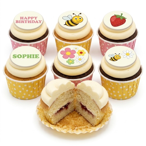Assortment of birthday cupcakes with bee, flower, strawberry, and 'Happy Birthday' toppers.
