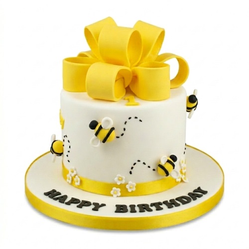 White round cake with yellow bow, fondant bees, white flowers, and a custom age topper.