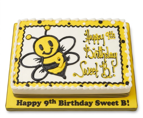 Rectangular white, yellow, and black birthday cake with a cartoon bee illustration and custom message.