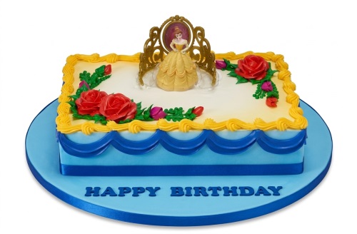 Rectangular Disney Princess Belle birthday cake with a Belle figurine, golden tiara, red roses, and blue and yellow icing.