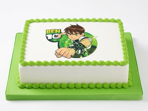 Rectangular white cake with green piped borders and a central edible image of Ben 10.