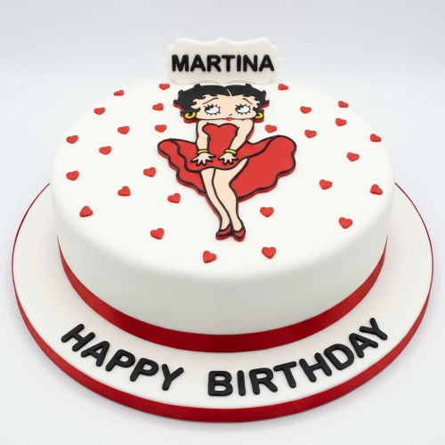 Round white Betty Boop birthday cake with red hearts and a red ribbon base, featuring a custom name plaque.