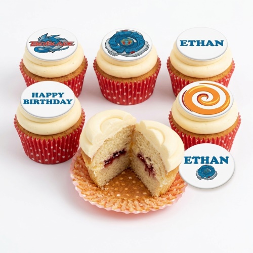 Beyblade themed birthday cupcakes with white frosting and red polka dot cases. Includes Beyblade logos and spinning top designs.