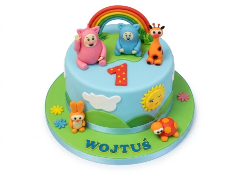 Single-tier 1st birthday cake with cartoon characters, rainbow, sun, and animal figures on a blue and green base.