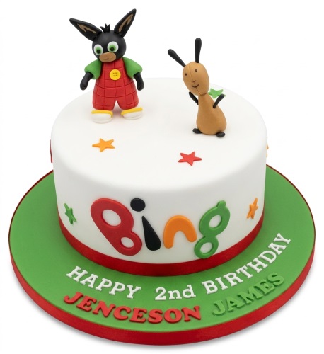 Round white Bing Bunny birthday cake with Bing and Flop figurines, stars, and personalised name.