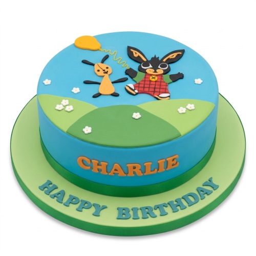 Round blue and green Bing Bunny birthday cake with Bing and Flop figures, personalised name.