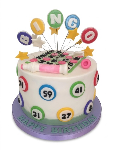 White round Bingo themed birthday cake with colourful number balls, a Bingo card, dabber, and 'BINGO' letter toppers.