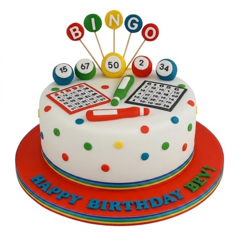 White round cake with bingo balls, cards, markers, and polka dots, on a red board with rainbow ribbon.