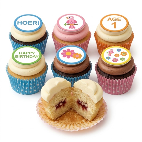 Assorted kids birthday cupcakes with custom age, name, bird, and flower toppers.