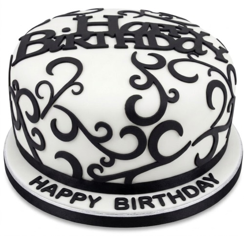 Round white birthday cake with black scrollwork and "Happy Birthday" text.