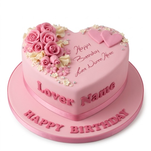 Pink heart-shaped birthday cake with sugar roses, small flowers, silver pearls, and custom message space.