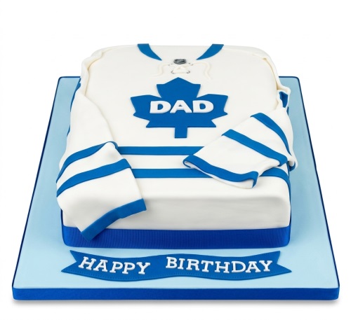 White and blue hockey jersey shaped birthday cake with a maple leaf and space for a custom name.