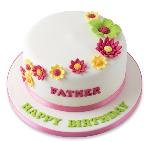 Round white fondant cake with pink, yellow, and green fondant flowers and a pink ribbon.