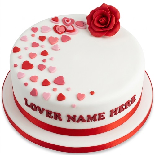 Round white cake with a red sugar rose, pink and red heart decorations, and a red ribbon around the base, with space for a personalised message.