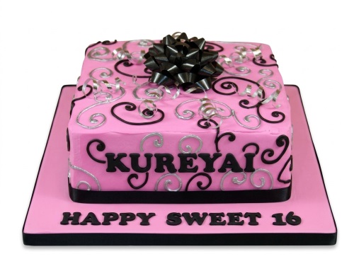 Square pink birthday cake with black and silver swirls, a black bow, and "Happy Sweet 16" message.
