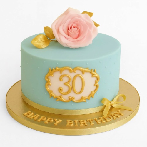 Round pastel blue birthday cake with pink sugar rose, gold leaves, gold frame for custom age, and gold 'Happy Birthday' lettering.
