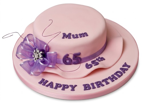 Pink lady's hat birthday cake with purple ribbon, bow, and custom age topper.