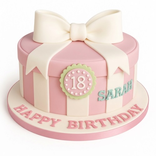 Pink and white striped gift box birthday cake with a large white bow, custom age medallion, and personalised name.