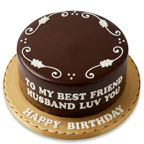 Round dark glazed birthday cake with white scrollwork and a custom message for a husband on a gold board.