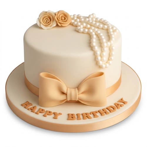 Single-tier cream birthday cake with gold bow, pearl strands, and two small roses.