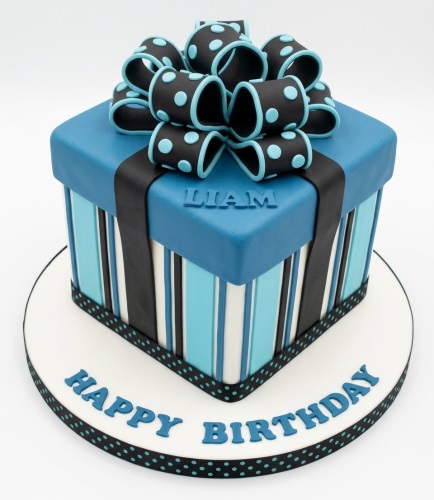 Square blue gift box birthday cake with black and blue polka dot bow and stripes.